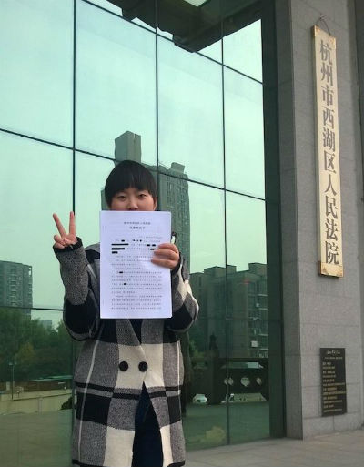 王丽领取判决书，结果令她很开心。